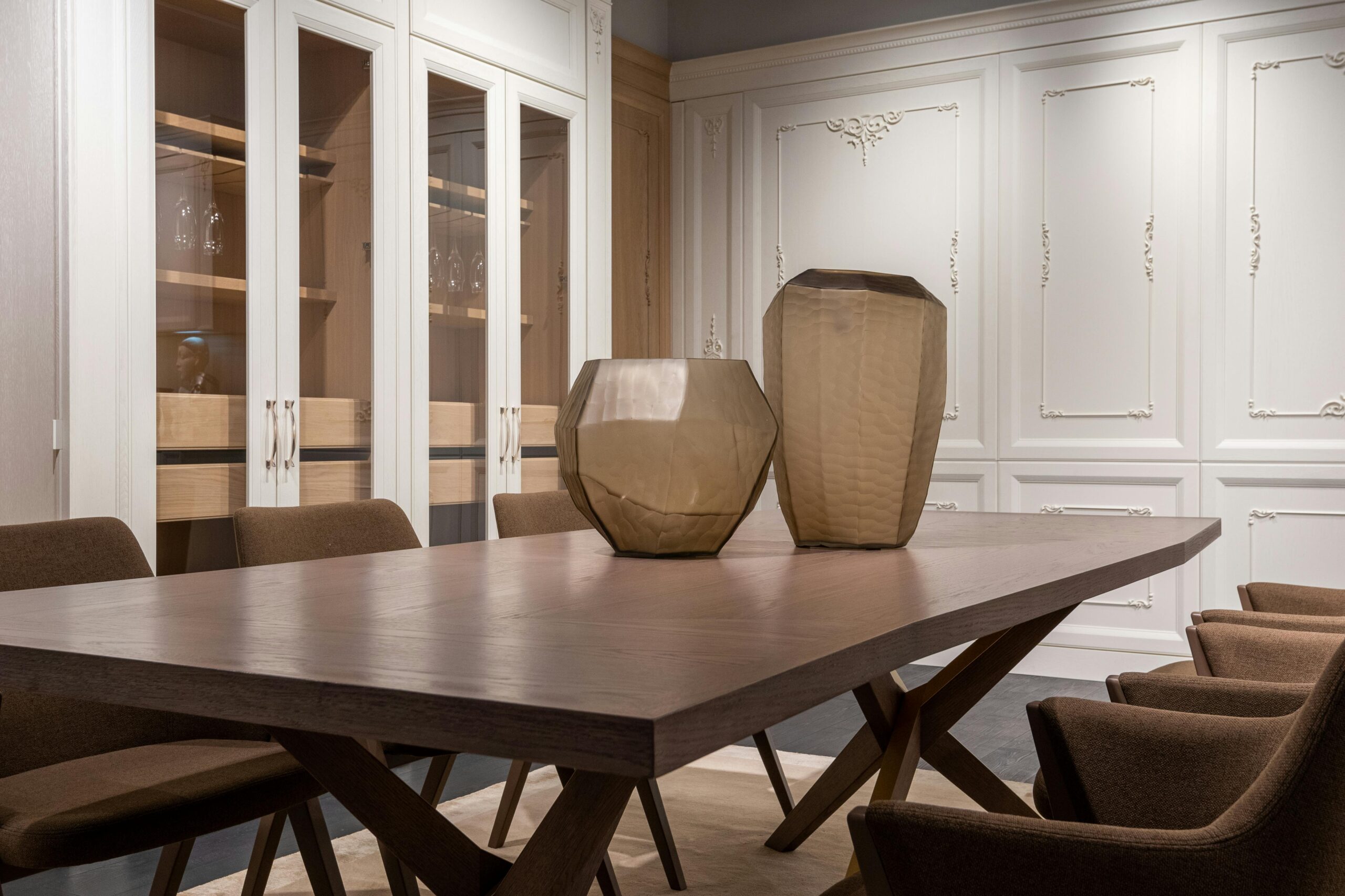Modern interior design of classic light dining room with creative vases on table